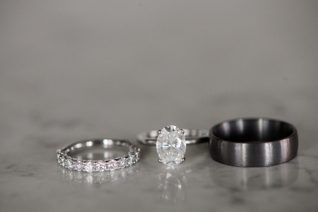 Oval diamond wedding ring with thin diamond wedding band and mens black wedding ring