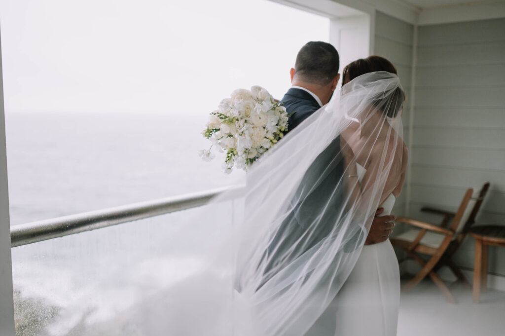 Bride and Groom Intimate Bridal Portraits Oceanfront with Long Cascading Veil