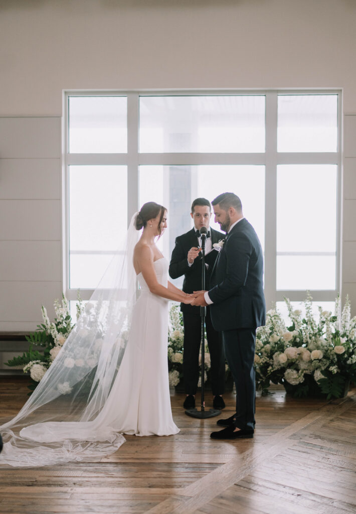 Cliff House Maine Intimate Indoor Wedding Ceremony with Stunning White Ground Floral Arch 