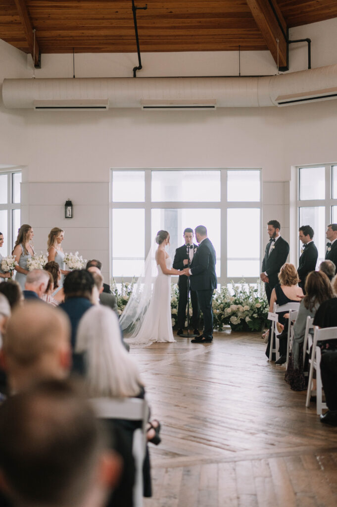 Cliff House Maine Intimate Indoor Wedding Ceremony with Stunning White Ground Floral Arch 