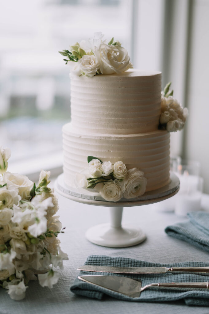 Simple Yet Elegant Two-Tiered White Wedding Cake with Fresh White Flowers
